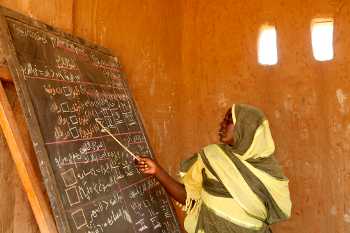 A teach using a blackboard