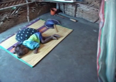 Child asleep ona mat on the floor